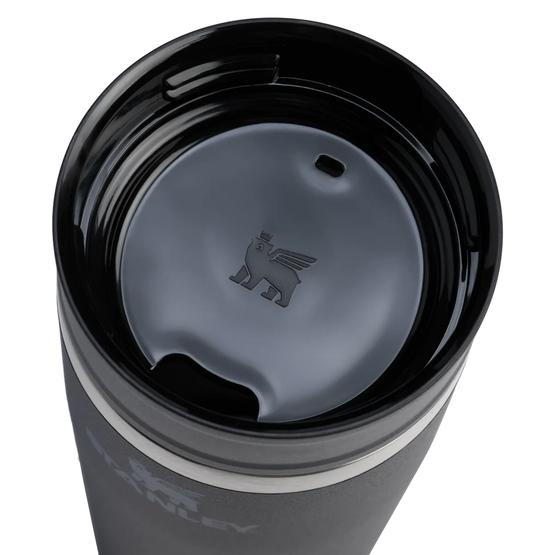 Stanley 1913 México dark grey stainless steel 473ml travel mug with two-part leak-proof lid and embossed winged bear logo.