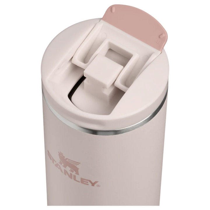 Stanley 1913 México light pink stainless steel travel mug with flip-top lid and silicone accents.